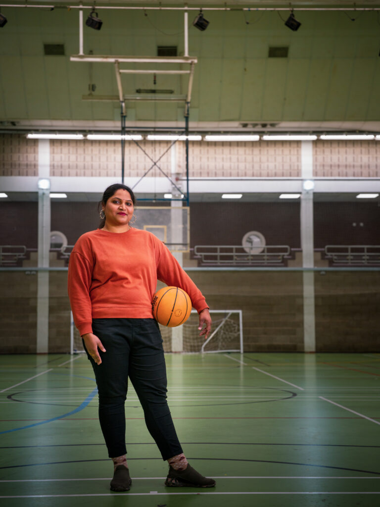 Member holding a basketball in the sports hall at Brentford Fountain Leisure Centre