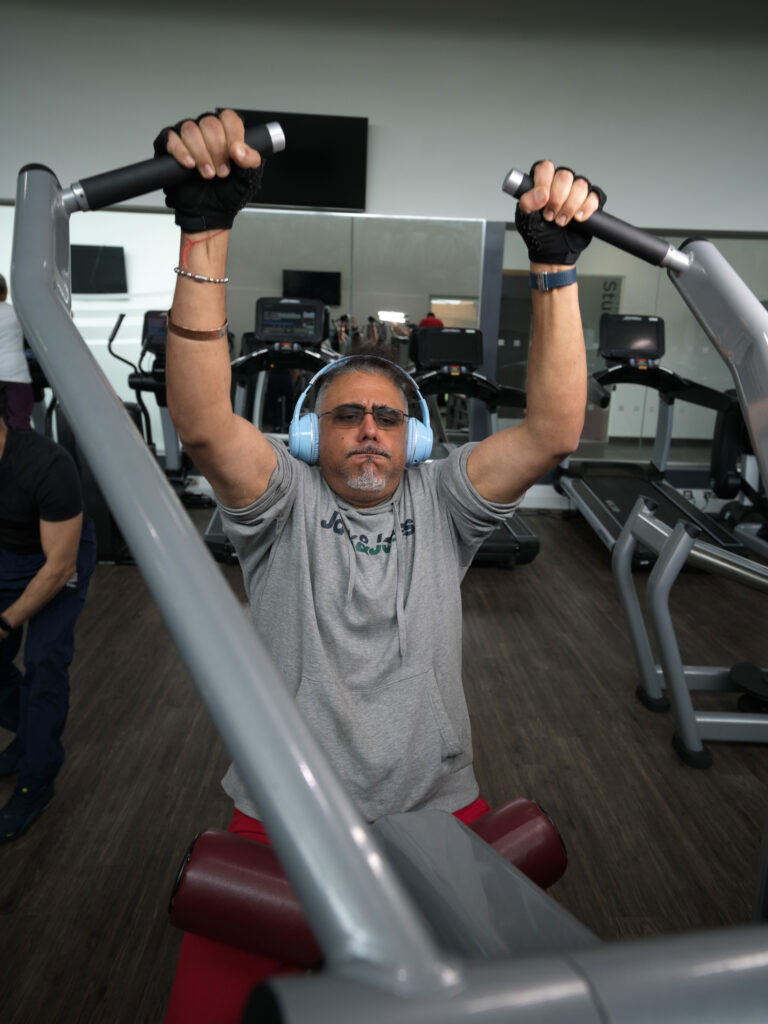 A man using a weights machine in the gym